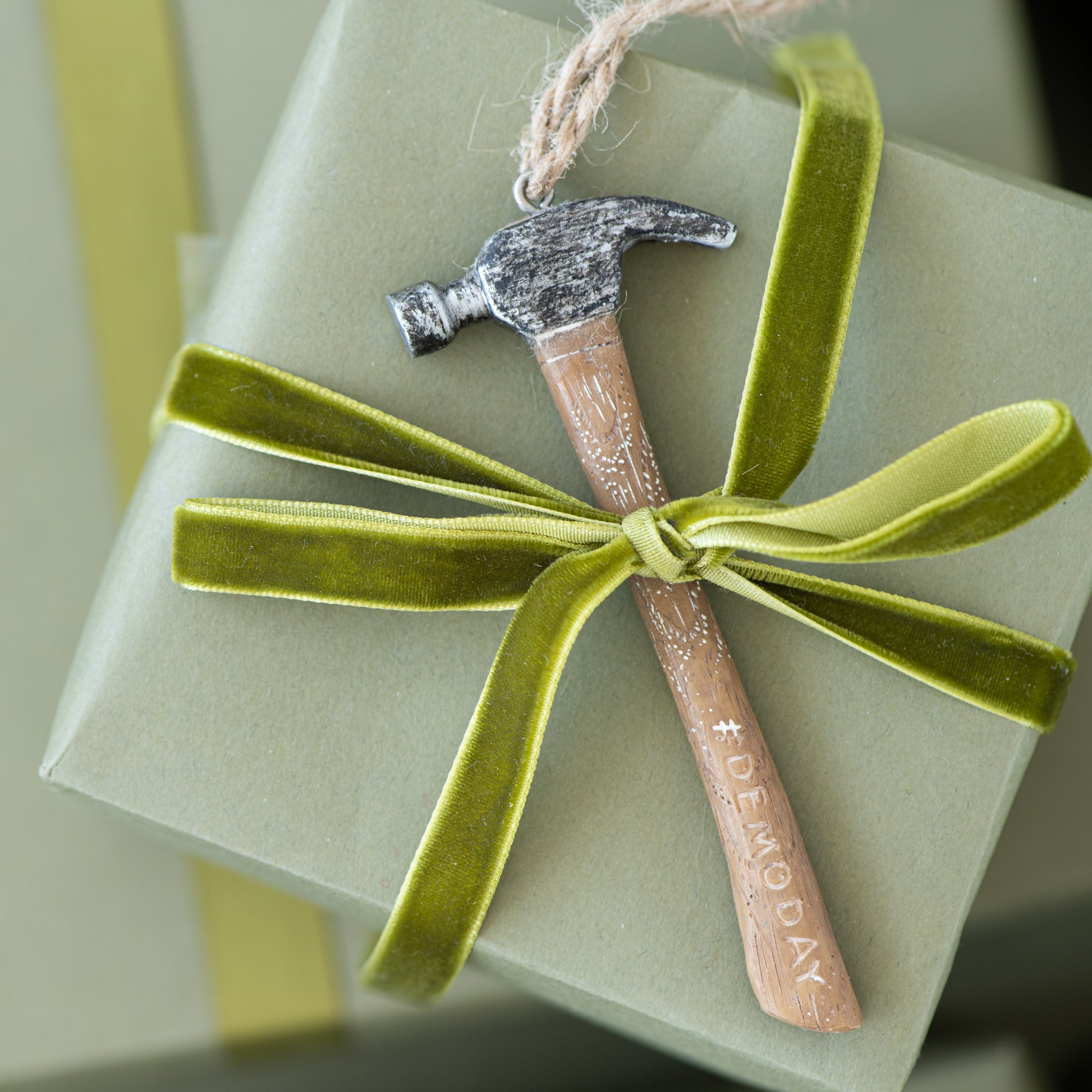 #DEMODAY Hammer Ornament shown attached to gift
