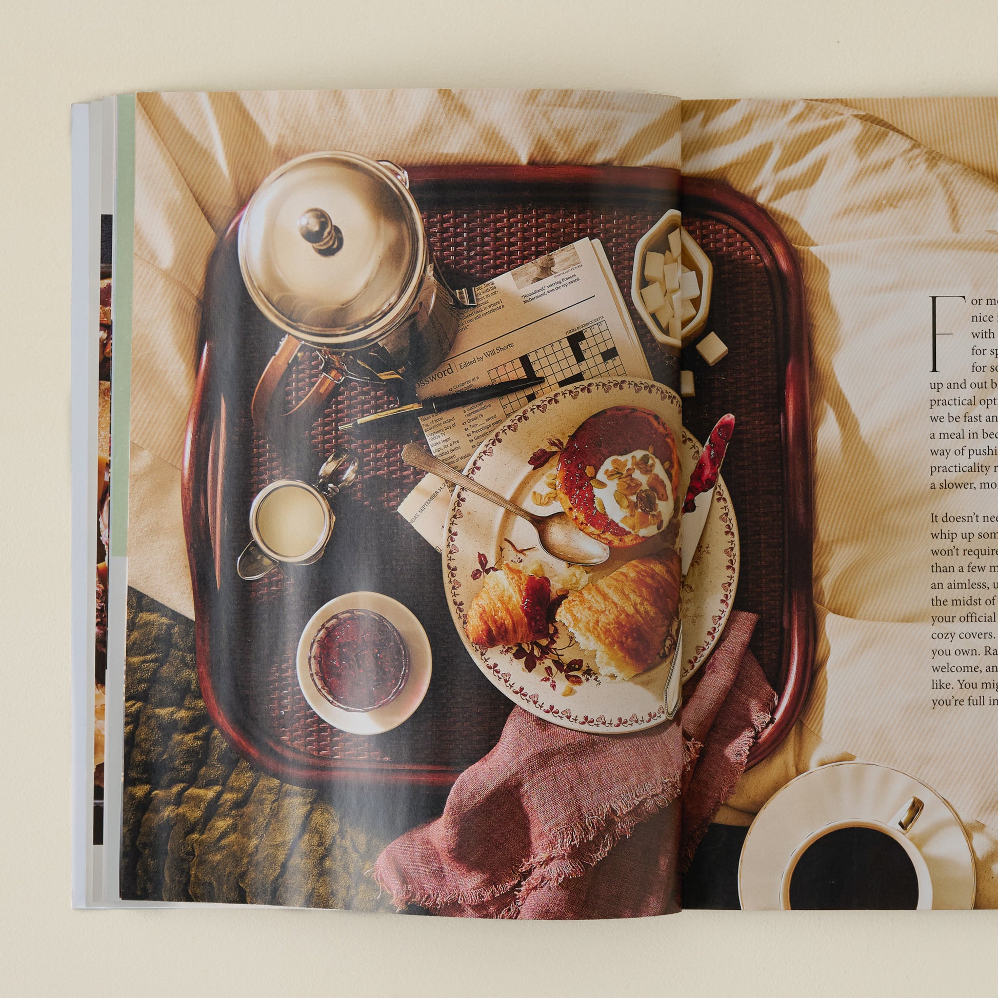 Magnolia Winter 2025 Journal picture captured of early morning breakfast of crossaint, grapefruit with coffee kettle and crossword puzzle.