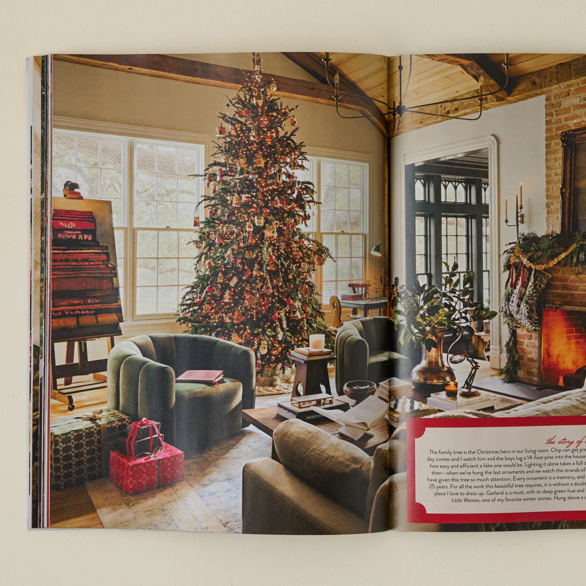 Magnolia 2025 Winter Journal photo captured of Christmas-themed living with wrapped presents, lit up Christmas tree and wood-burning fireplace