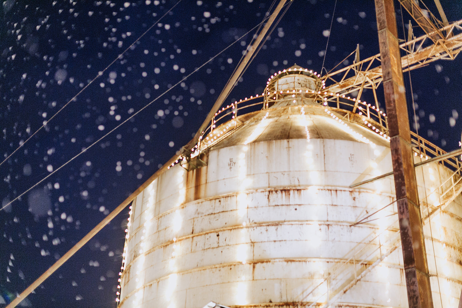the silos at night in winter, with twinkle lights and snow
