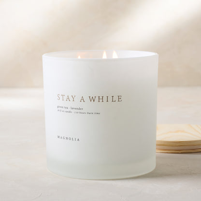 magnolia stay a while candle with wood lid notes scents of green tea and lavender