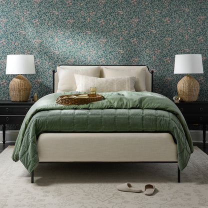 Colette bed in bedroom with floral wallpaper and dusty green cotton duvet