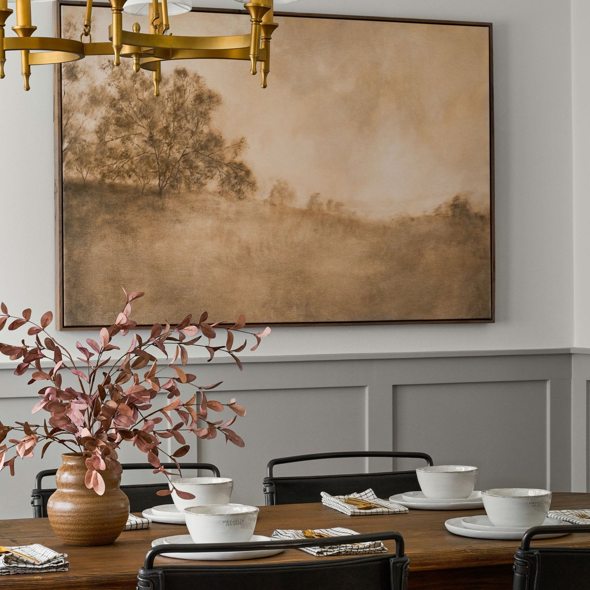 Framed art piece called Revival hanging on dining room wall