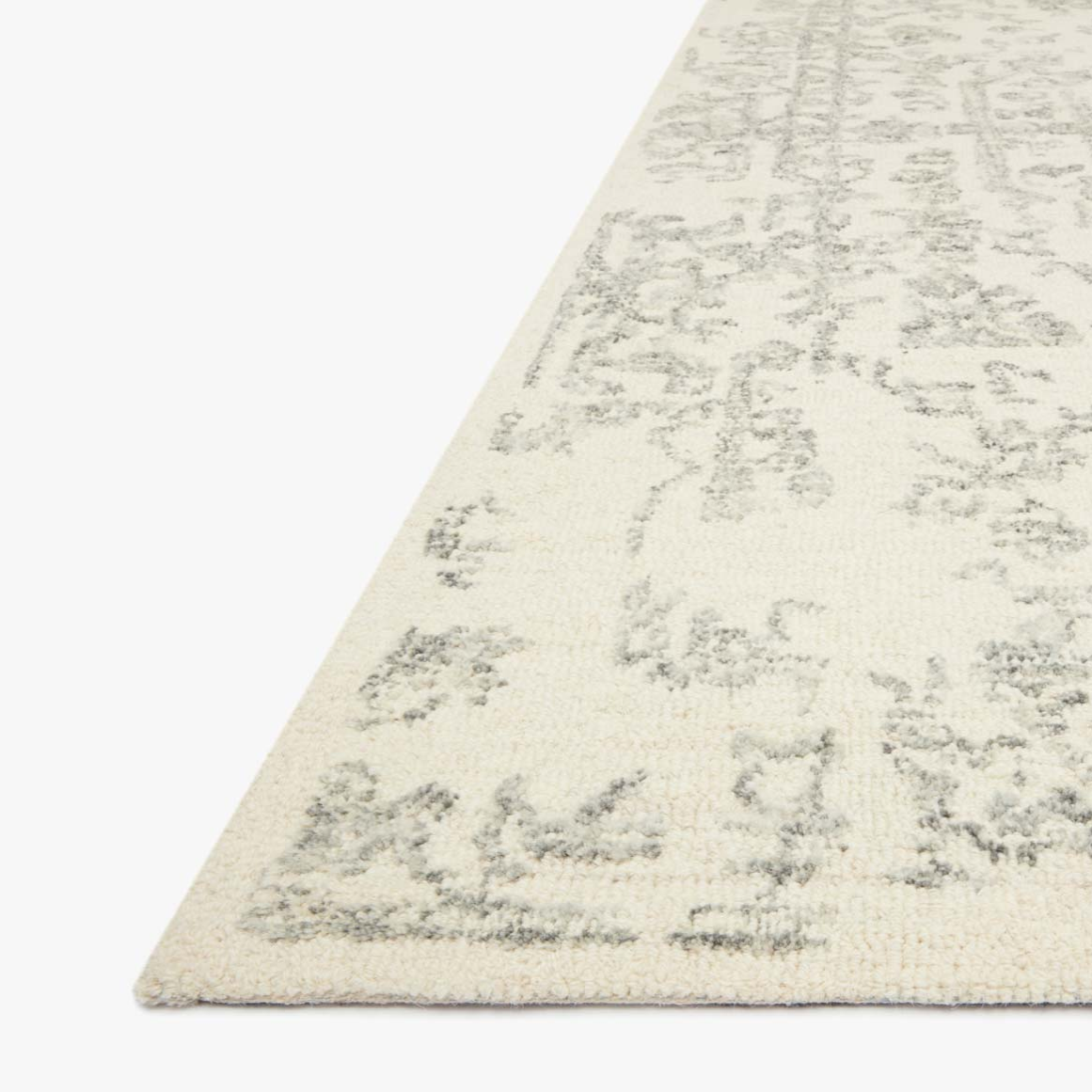 cream and grey distressed area rug with traditional detail