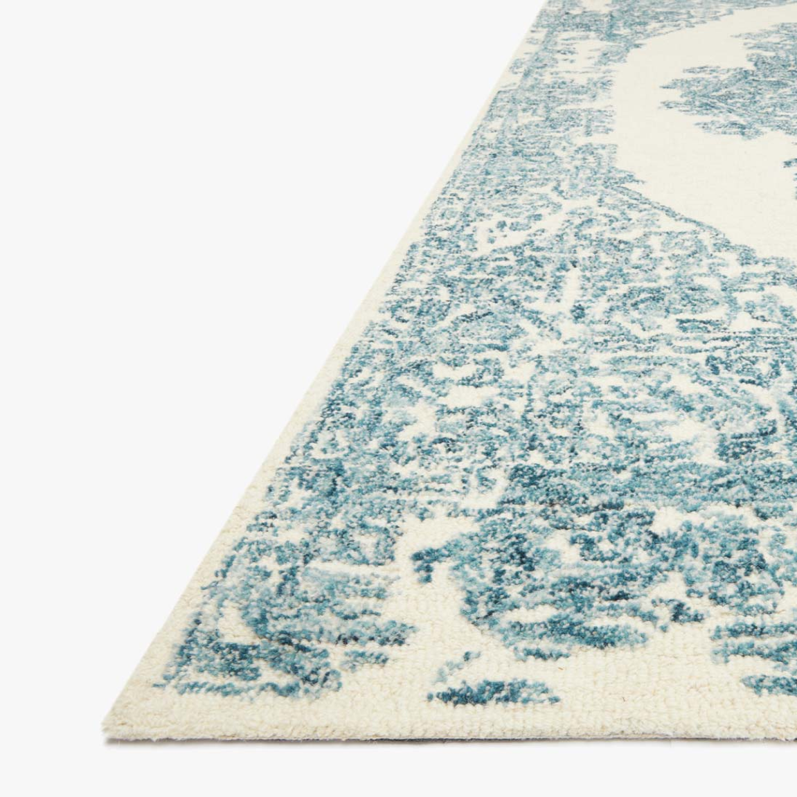 cream rug with blue traditional detail