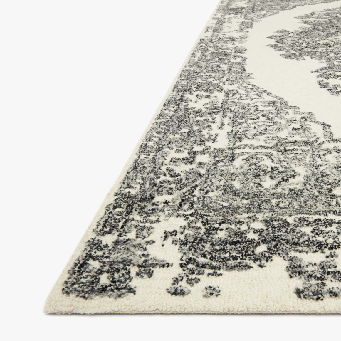 cream area rug with black traditional patterns and detail