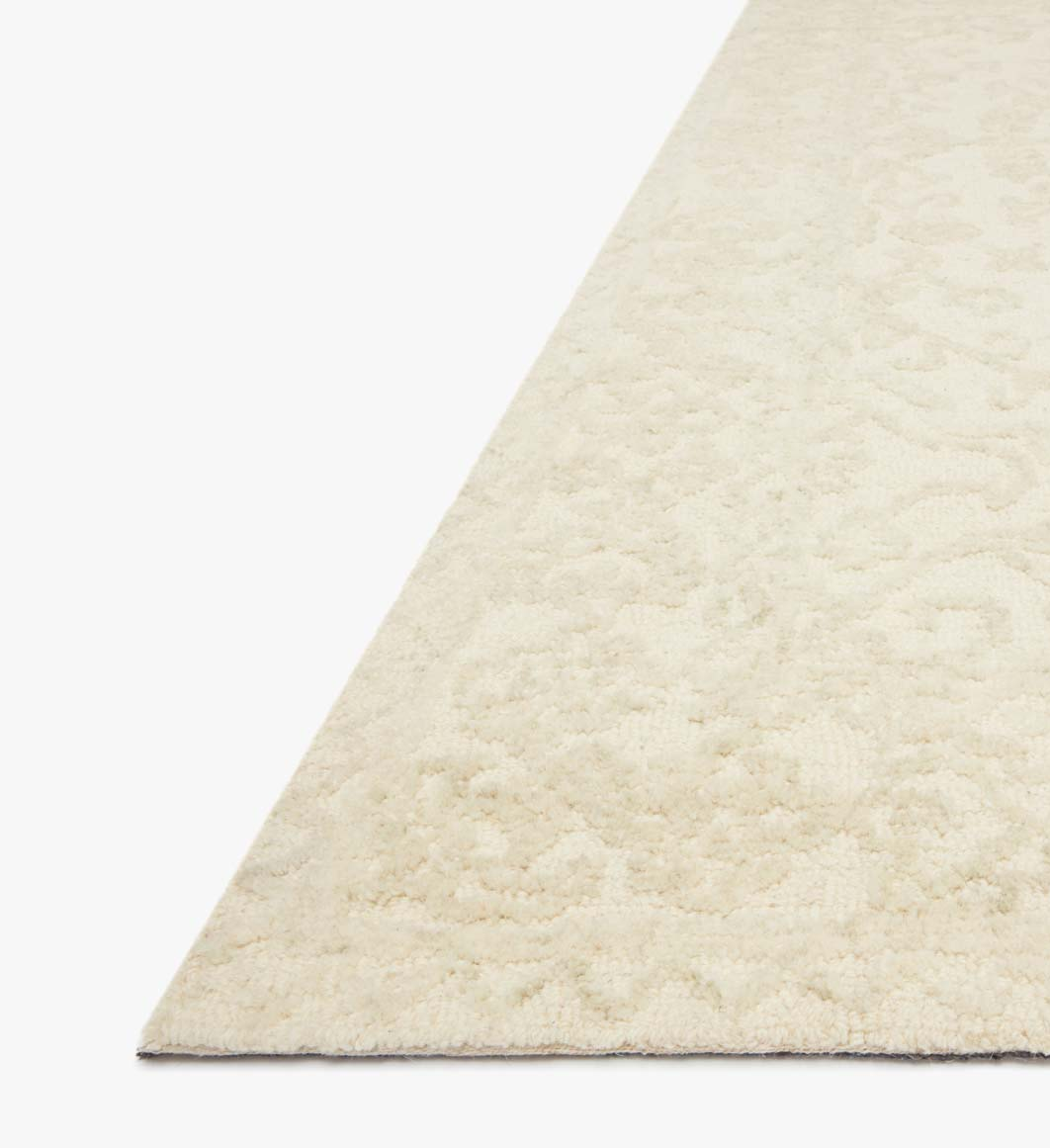 cream and light grey distressed rug with traditional detail