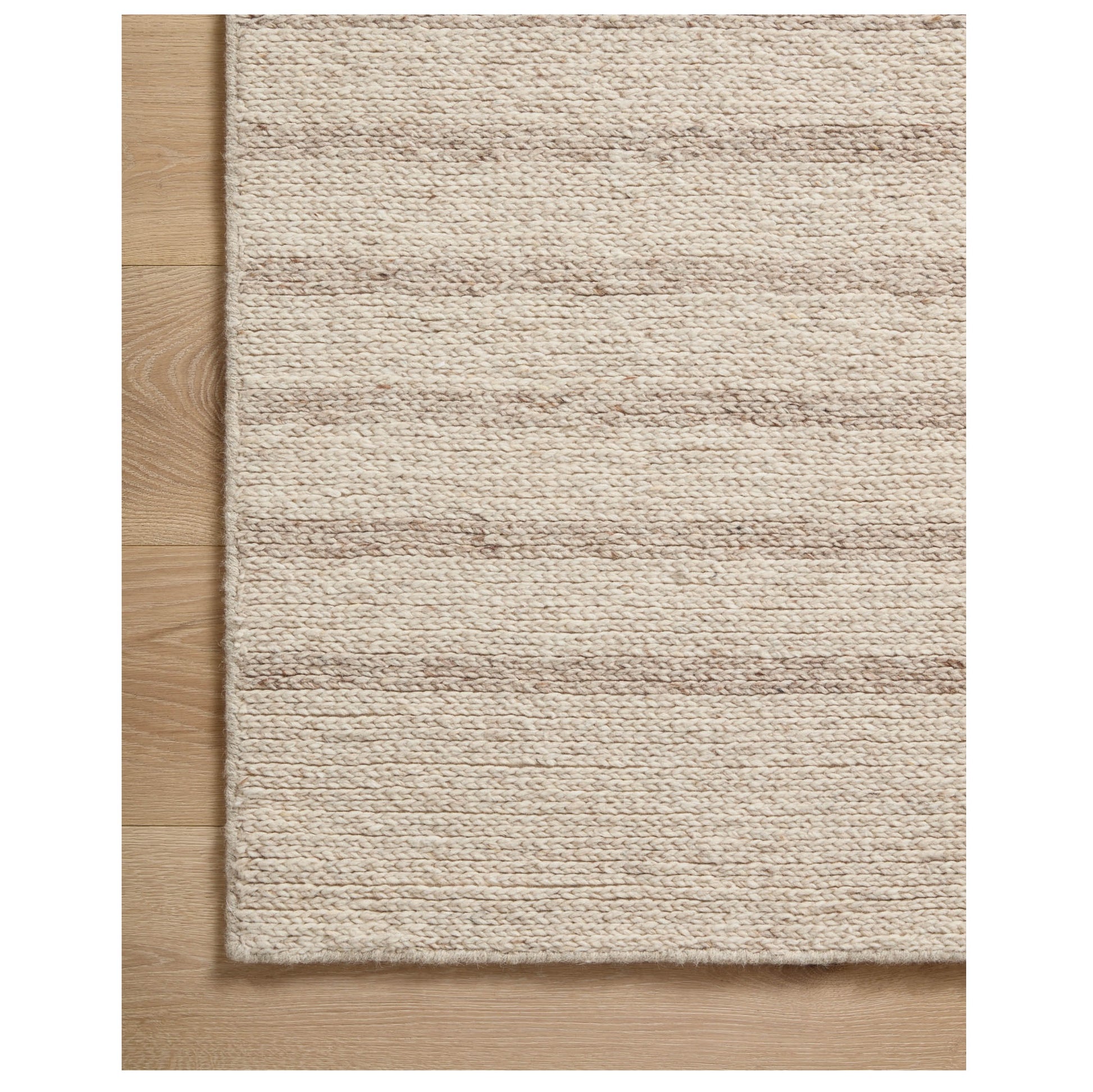 Ashby Oatmeal Sand Rug corner on wood floor