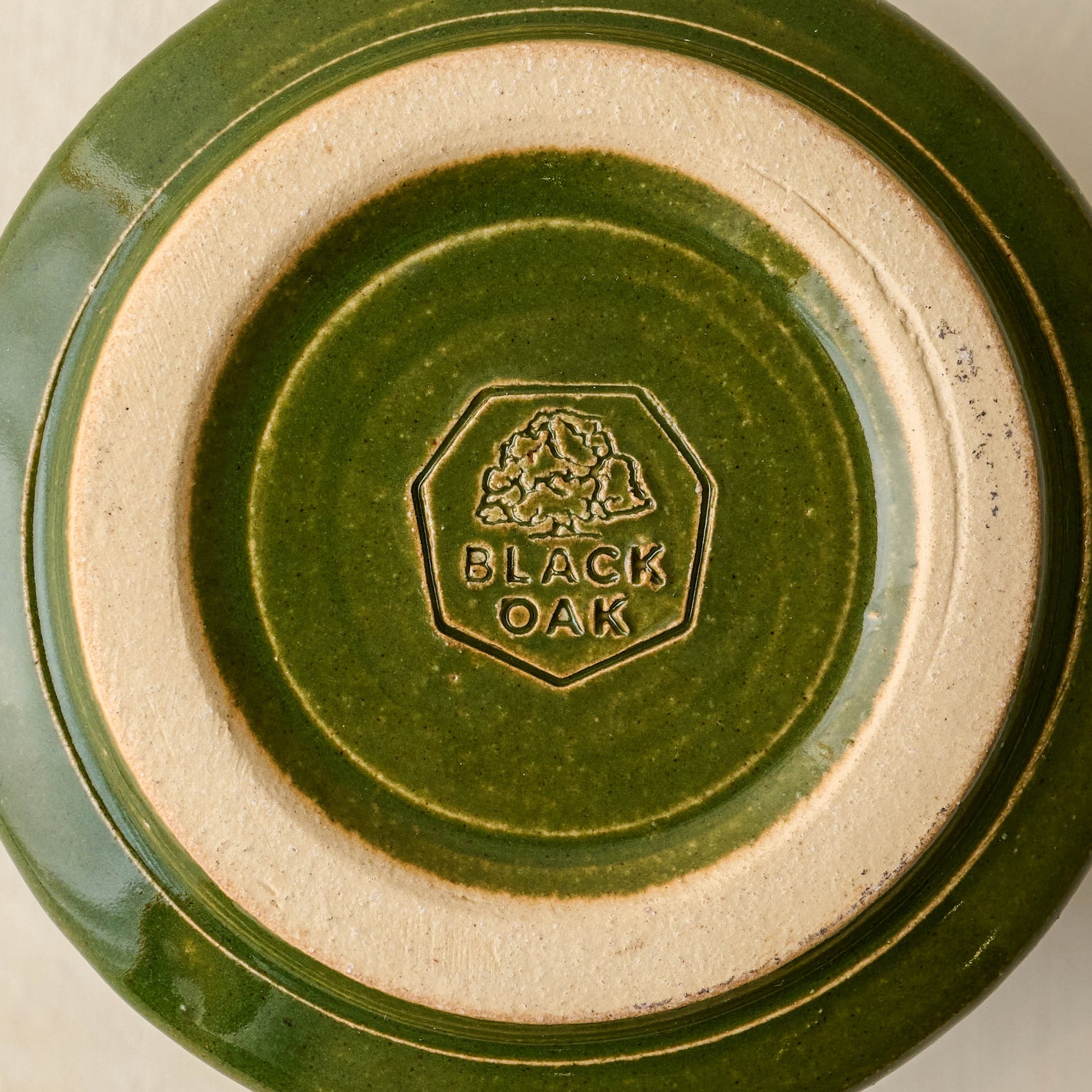Magnolia Established Mug - Green close up of bottom of mug with black oak logo