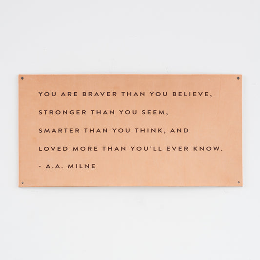 leather wall sign with a quote by a.a. milne