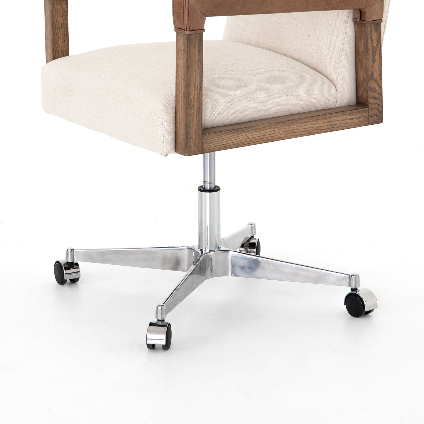 cream linen desk chair with leather-wrapped wooden arms and chrome metal base with wheels