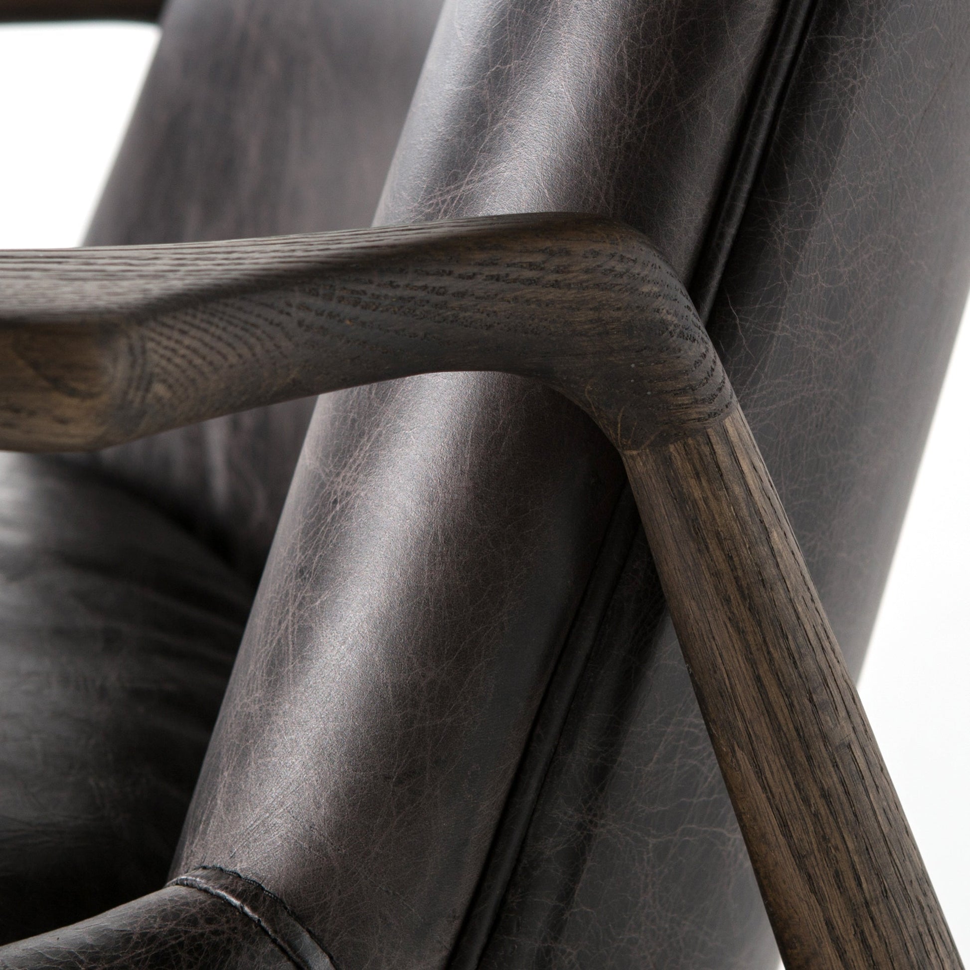 distressed black leather mid century modern arm chair with wooden arms and legs