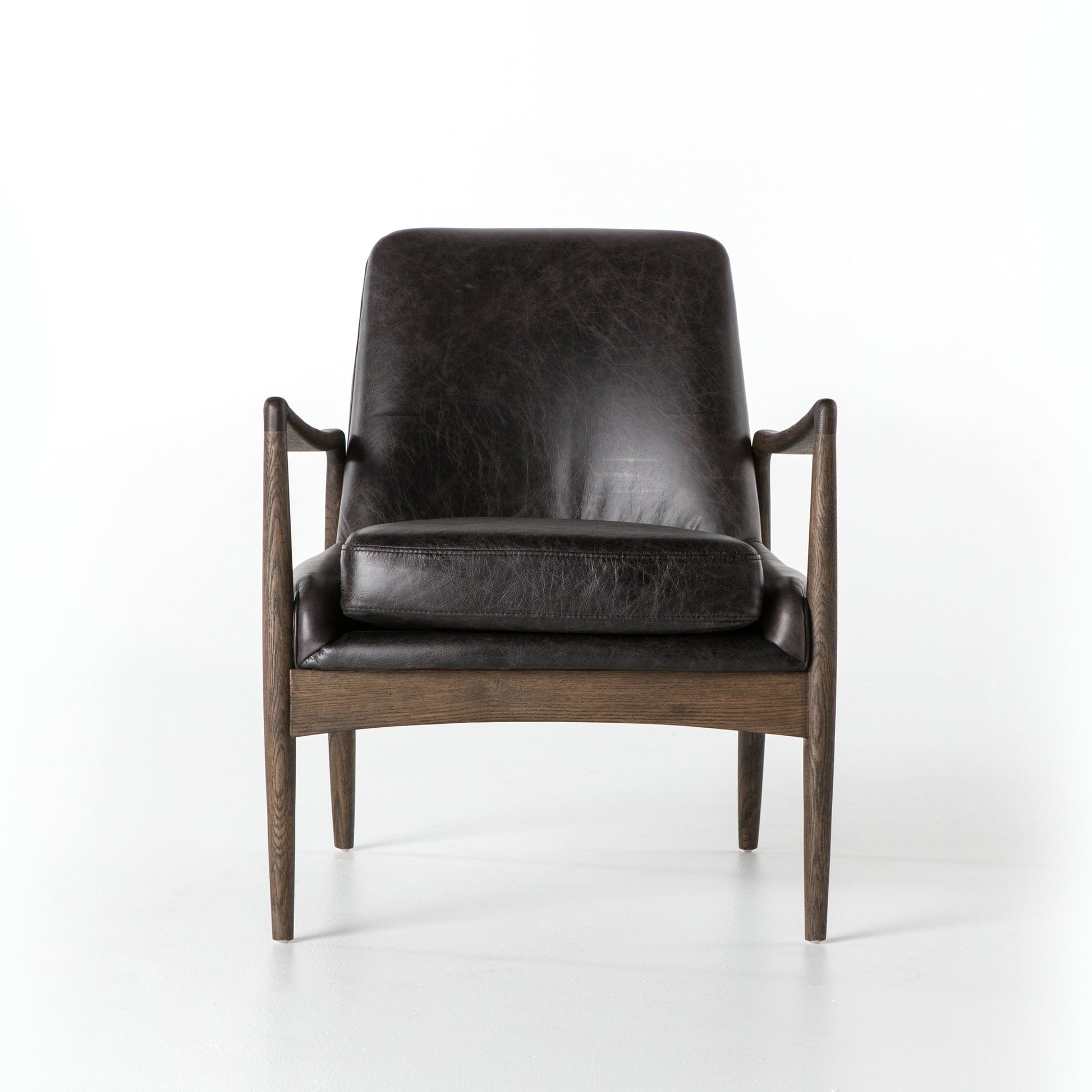 distressed black leather mid century modern arm chair with wooden arms and legs