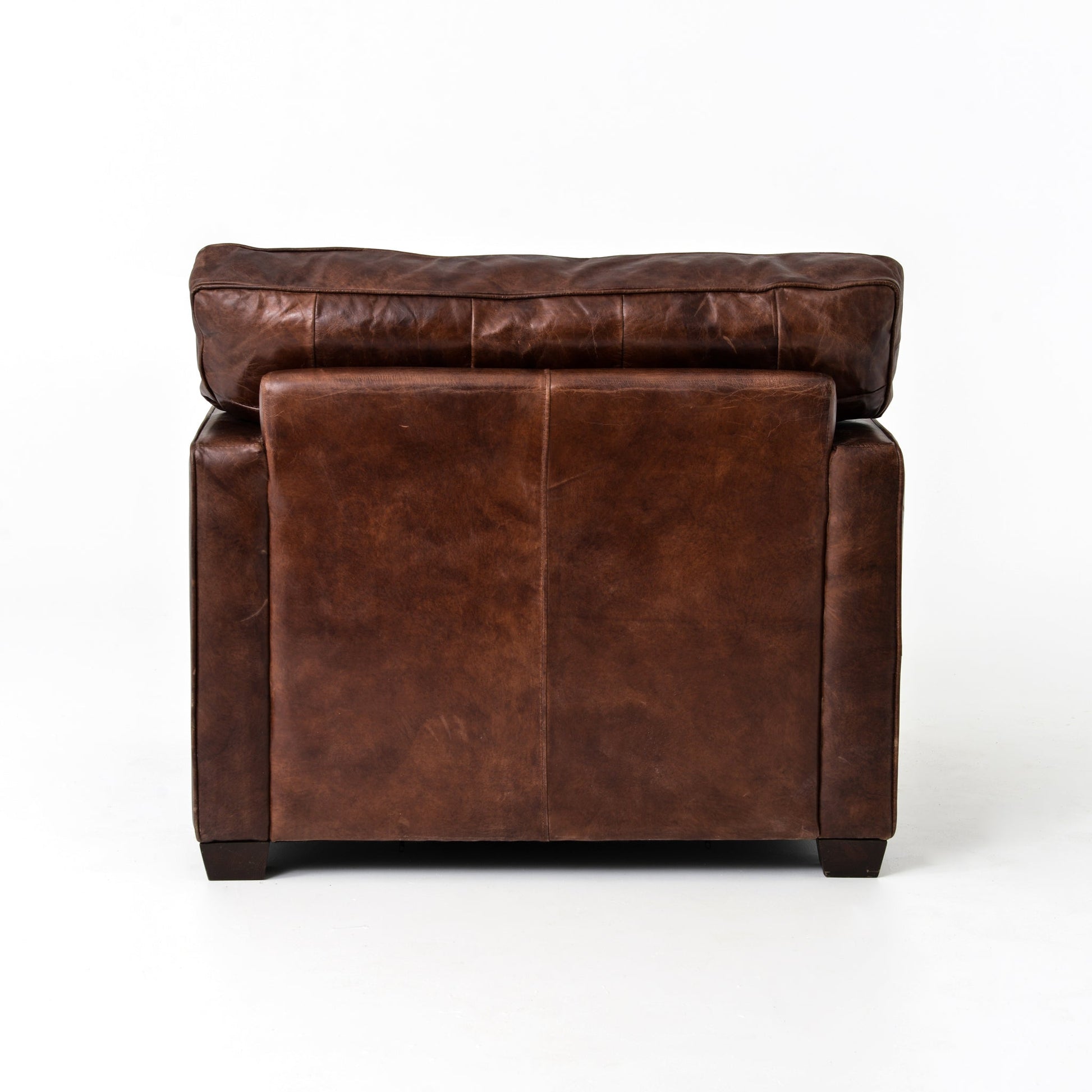 medium brown leather arm chair with nailhead arms