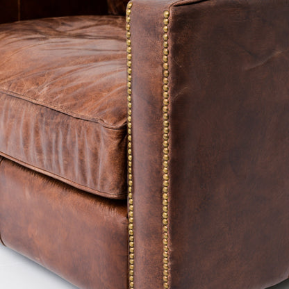 medium brown leather arm chair with nailhead arms