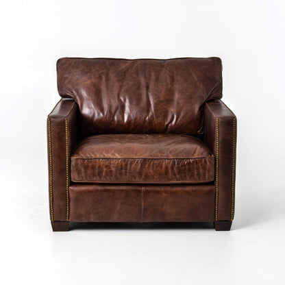 medium brown leather arm chair with nailhead arms