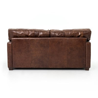 medium brown leather sofa with nailhead arms