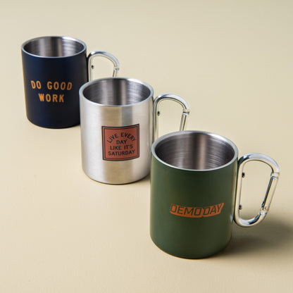 green stainless steel mug with "demoday" printed on the side with silver carabiner handle