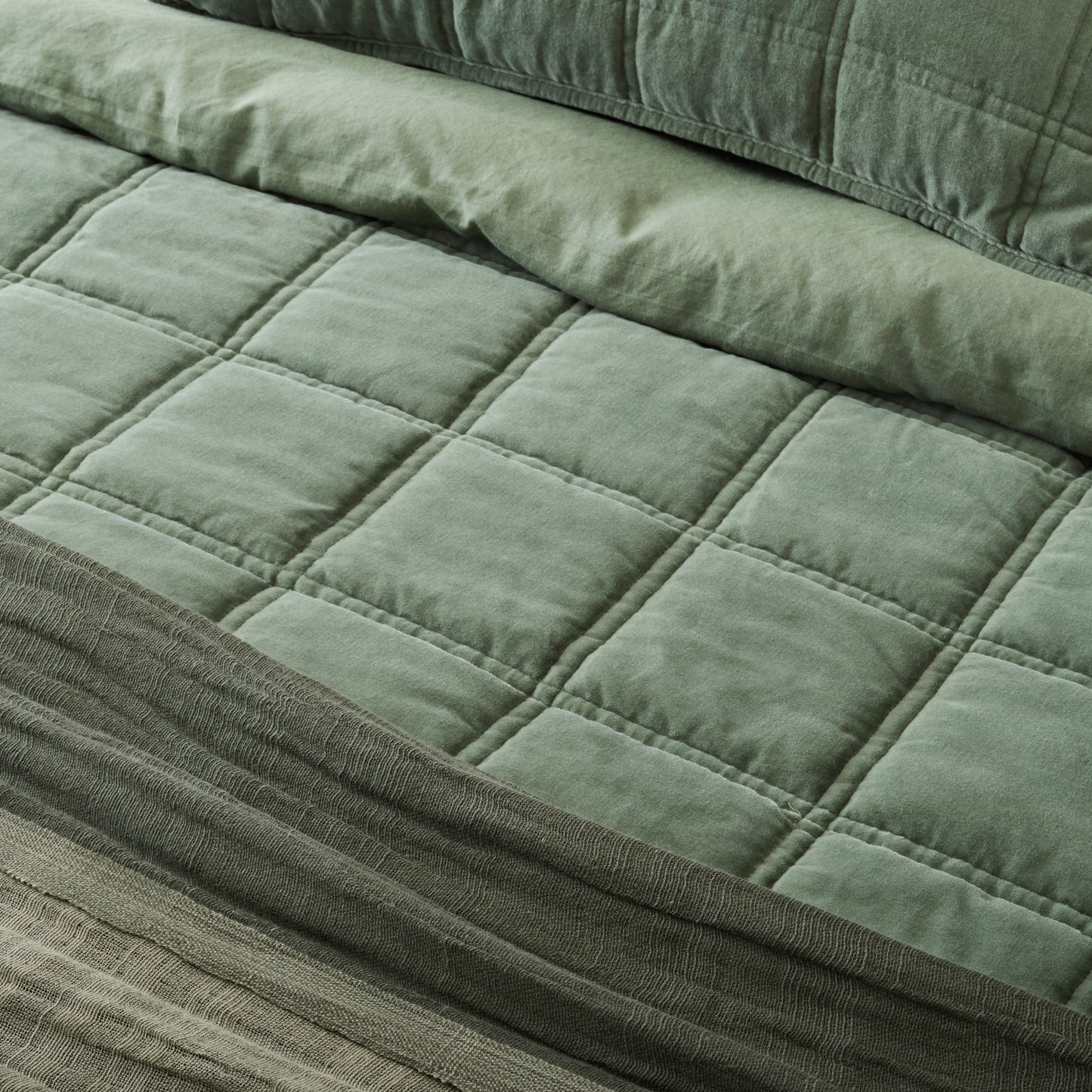 Weekend Velvet Quilt - Dusty Green on a made bed