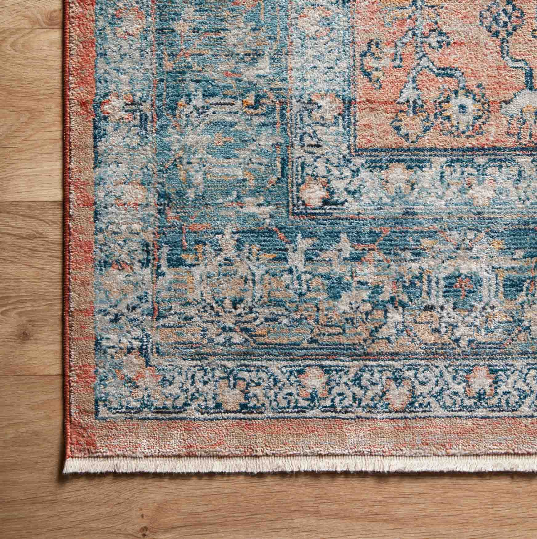 blue and coral orange traditional style rug with floral patterns and detail