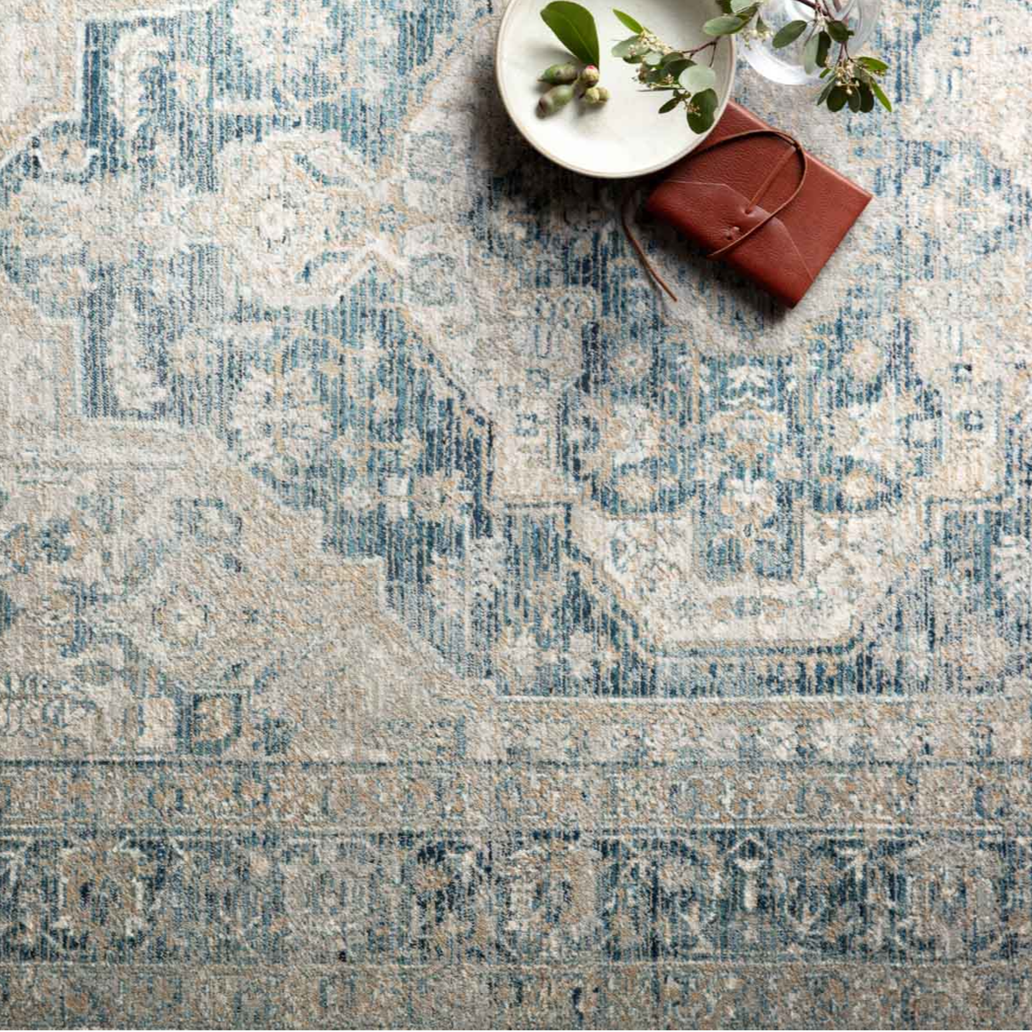 beige and blue traditional area rug with floral detail