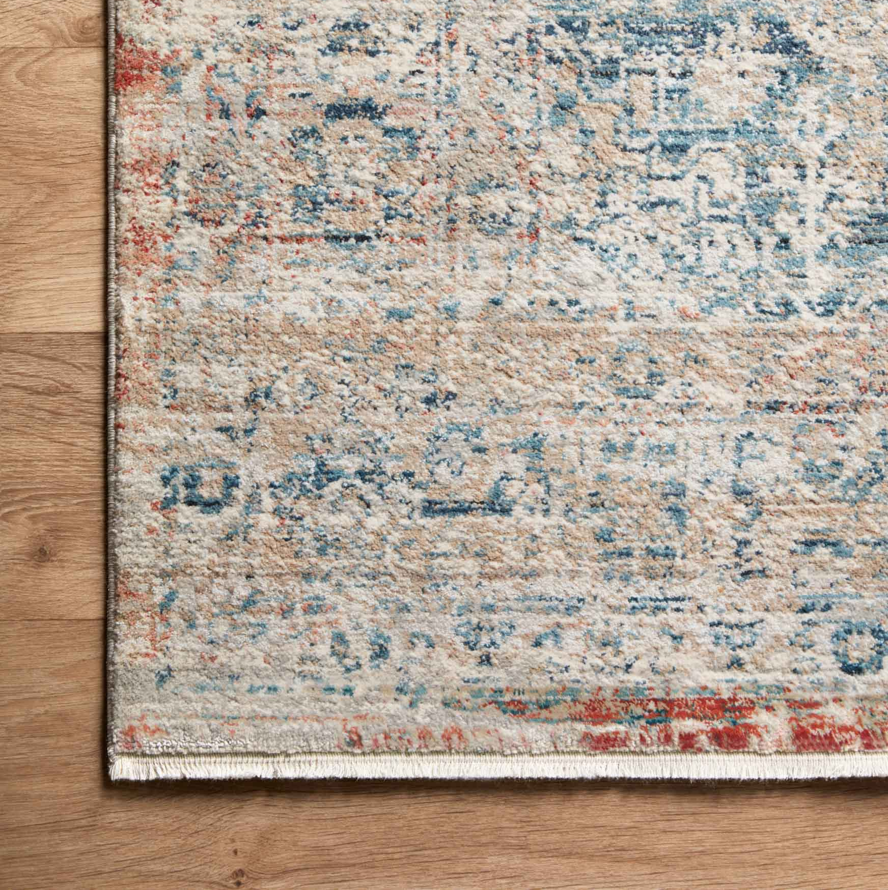distressed multi-colored traditional area rug with floral detail