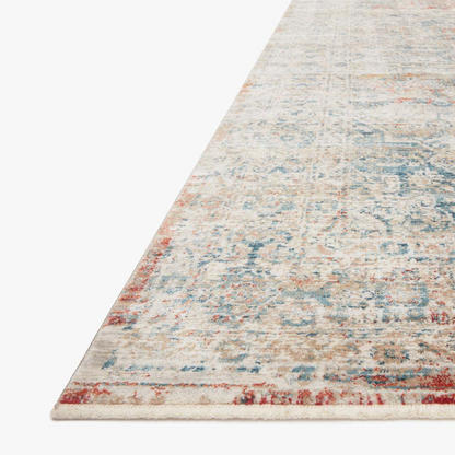 distressed multi-colored traditional area rug with floral detail