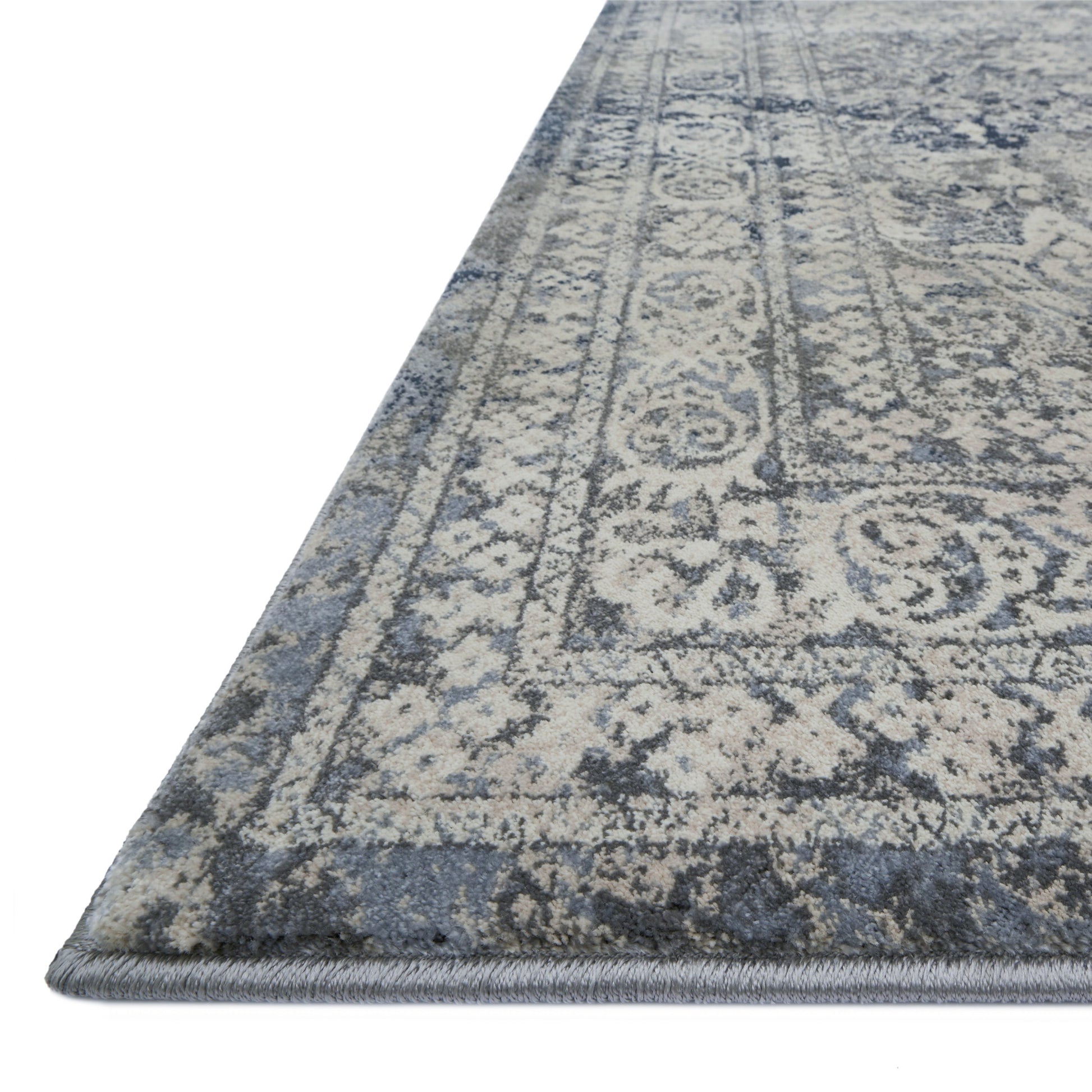 dark grey distressed rug with floral pattern