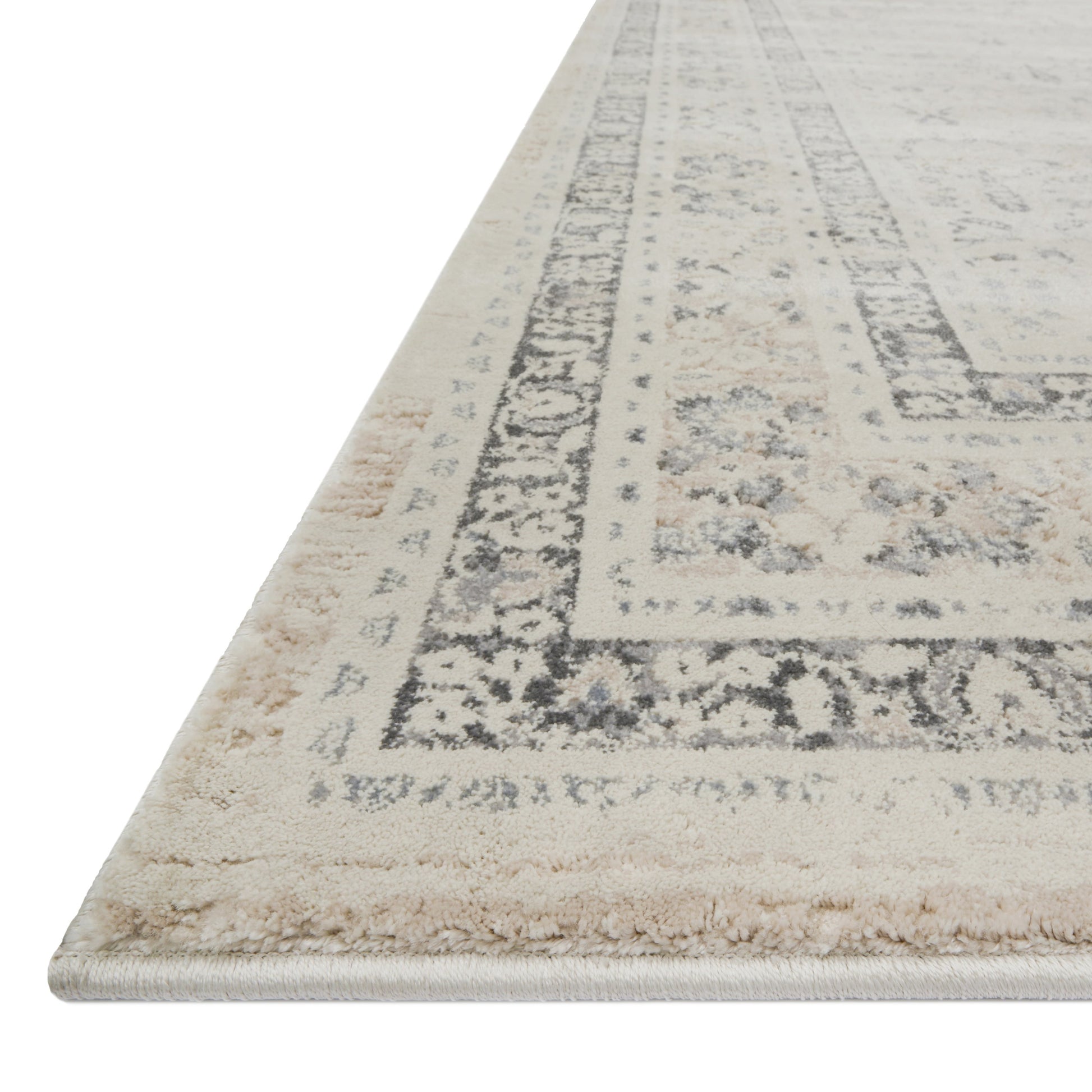 ivory and tan distressed rug with floral detail
