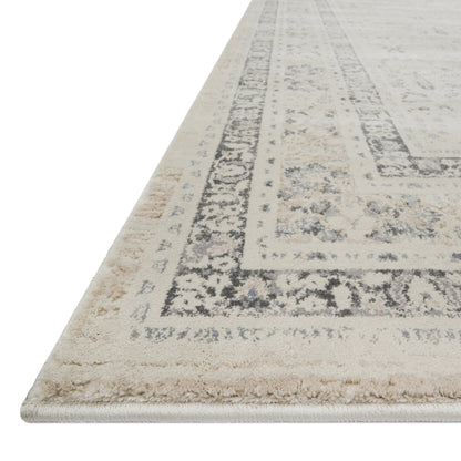 ivory and tan distressed rug with floral detail