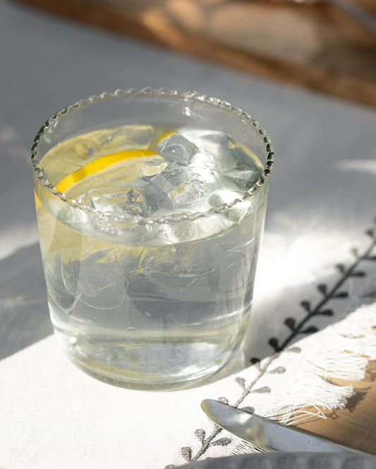 Elizabeth Bottle Cut Glass Tumbler in small size with iced water and lemon