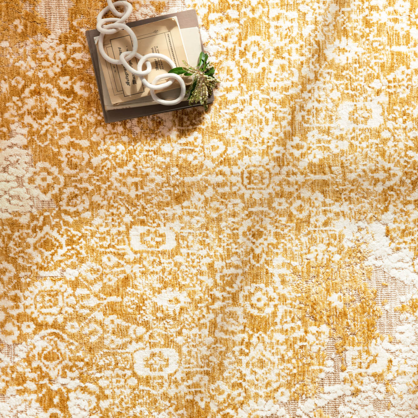 golden yellow distressed area rug with floral detail