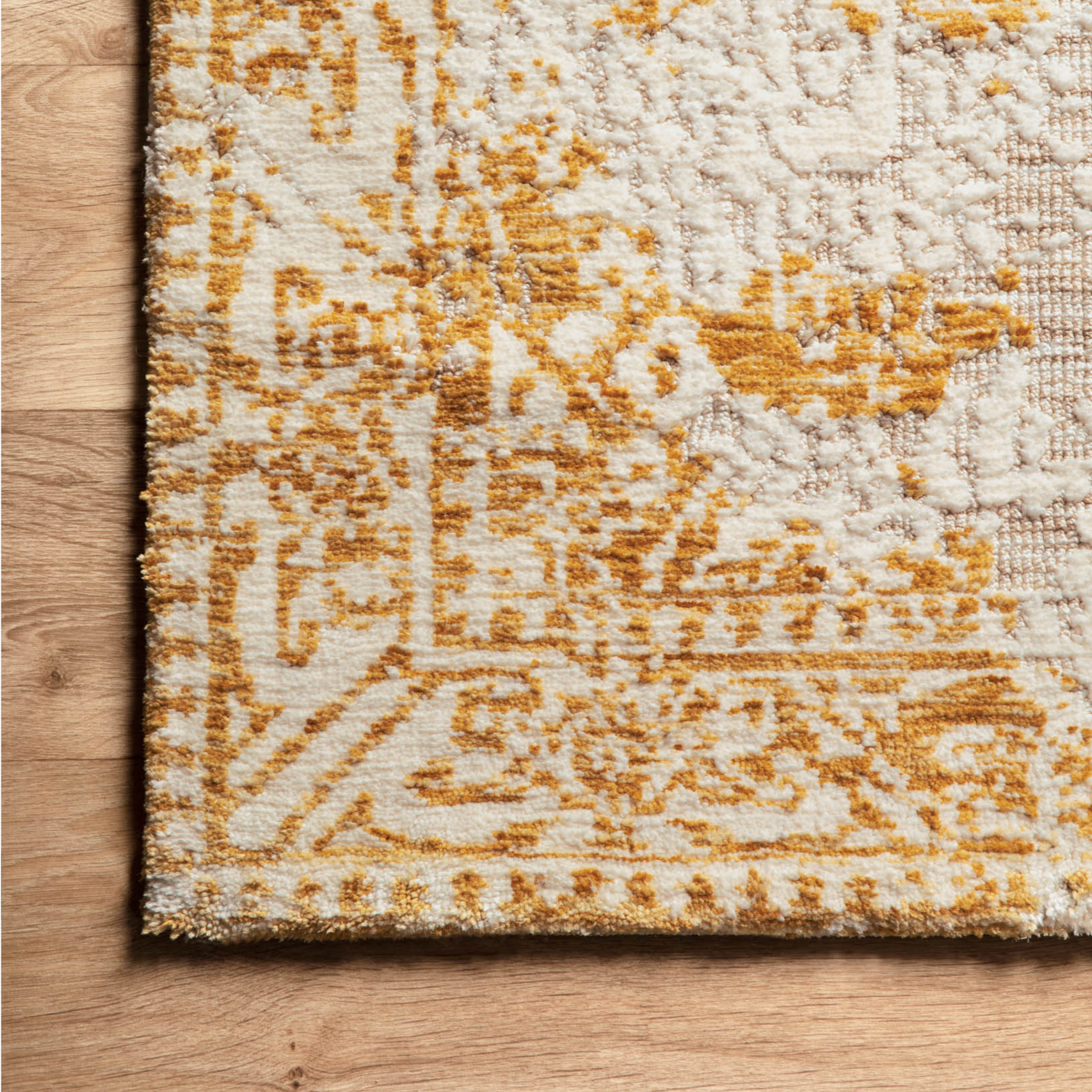 golden yellow distressed area rug with floral detail