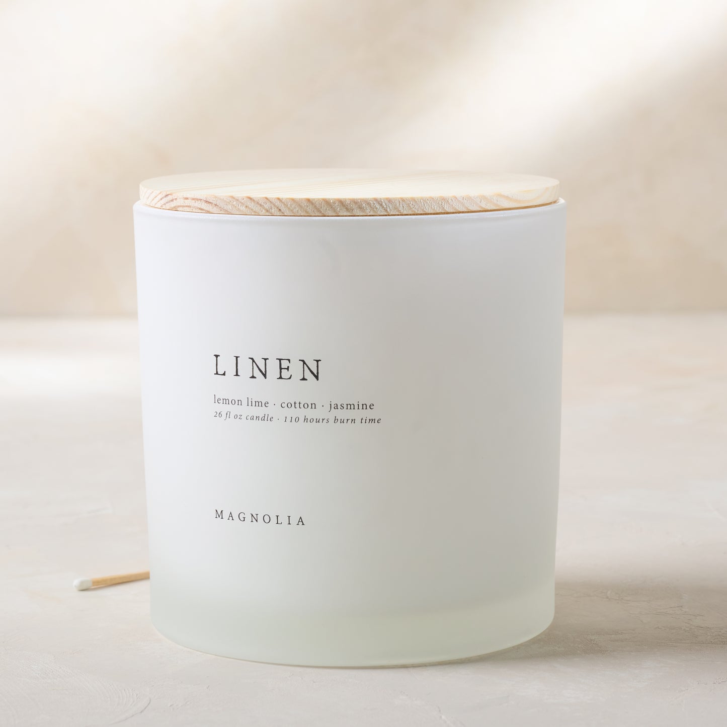 magnolia linen candle with wood lid notes scents of lemon lime cotton and jasmine