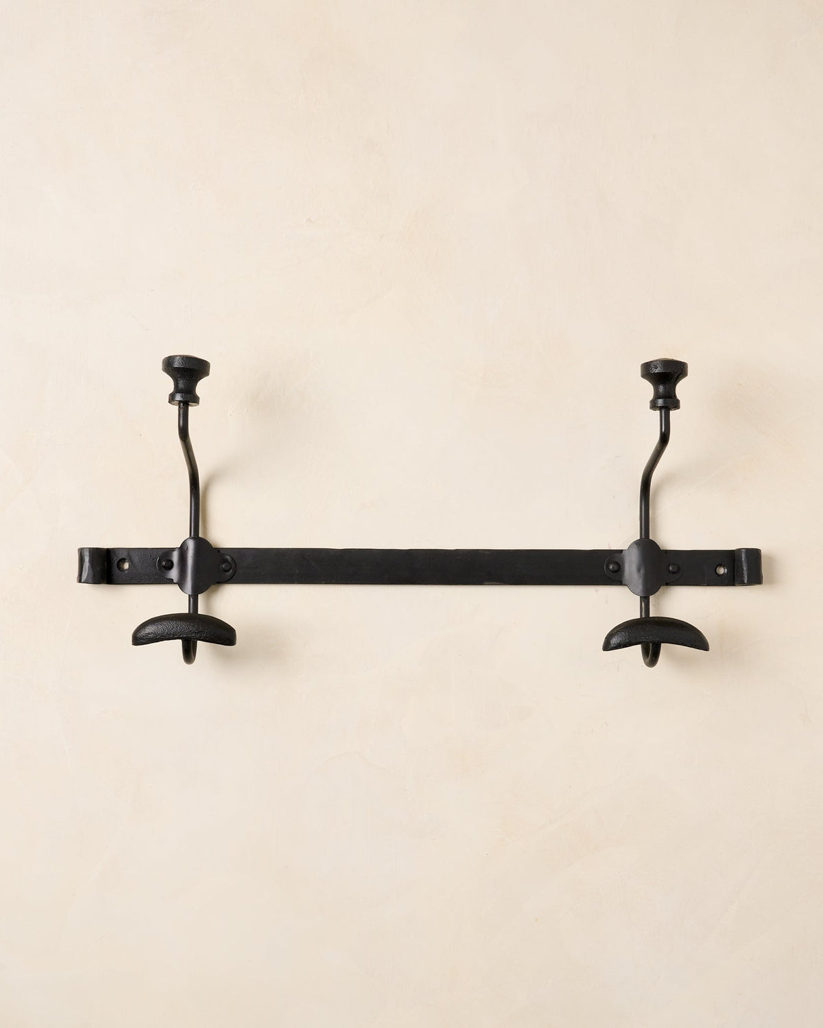 Close up of short duke metal wall hooks. 