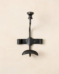 Close up of single duke metal wall hook. 