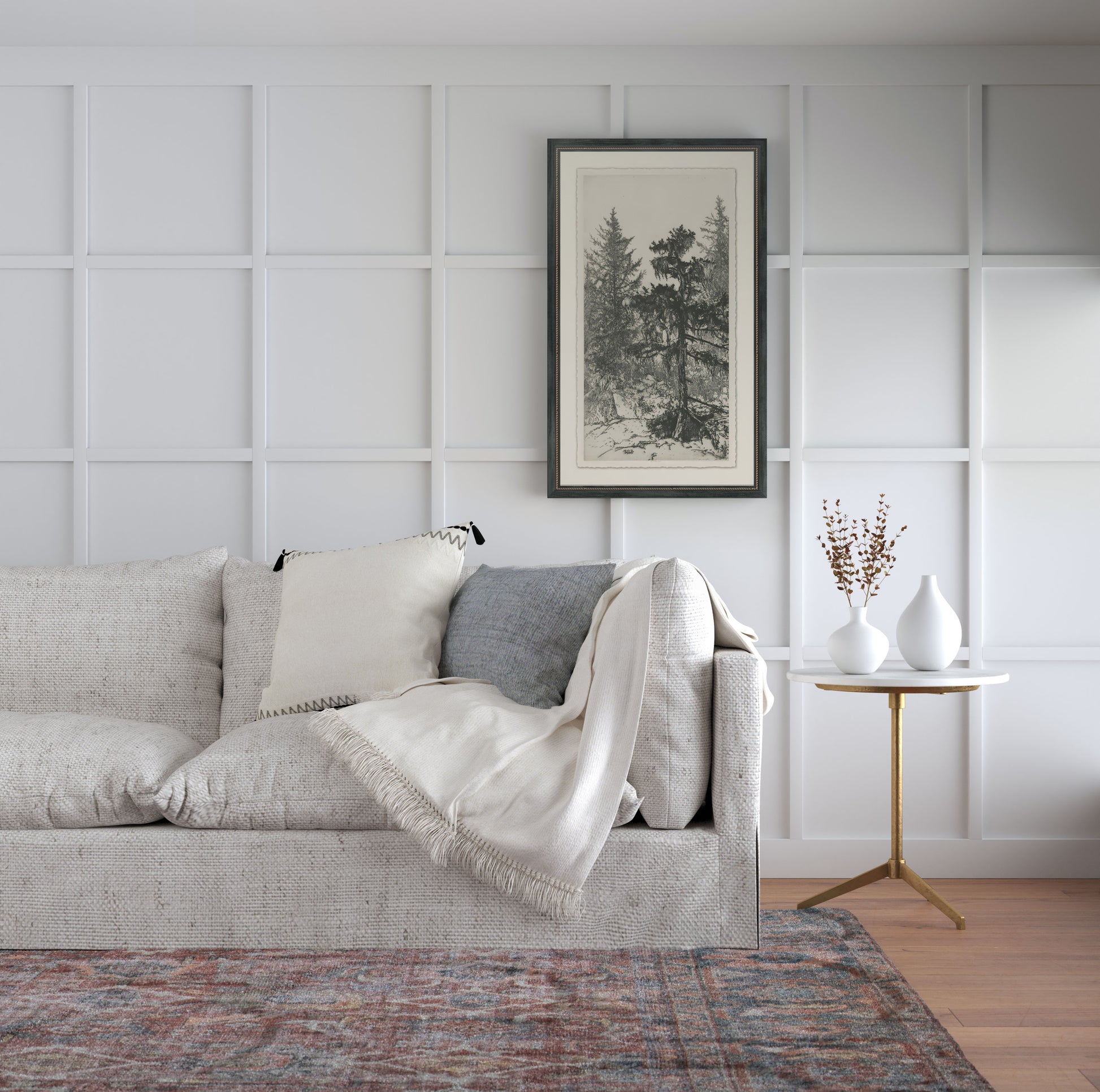 Framed wall art called Tall Trees II hanging on wall above grey sofa