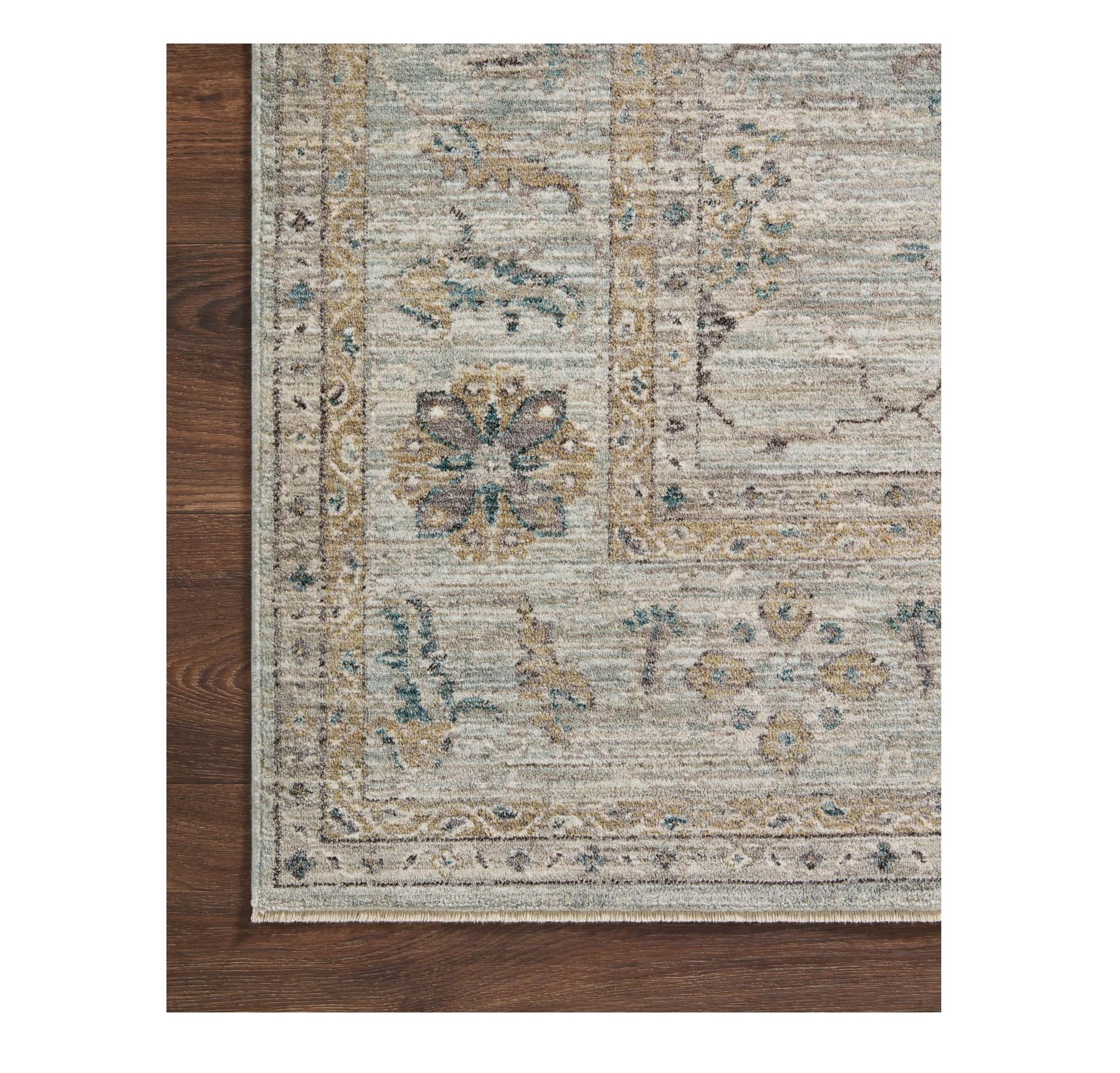 Millie Sky Gold Rug corner on wood floor
