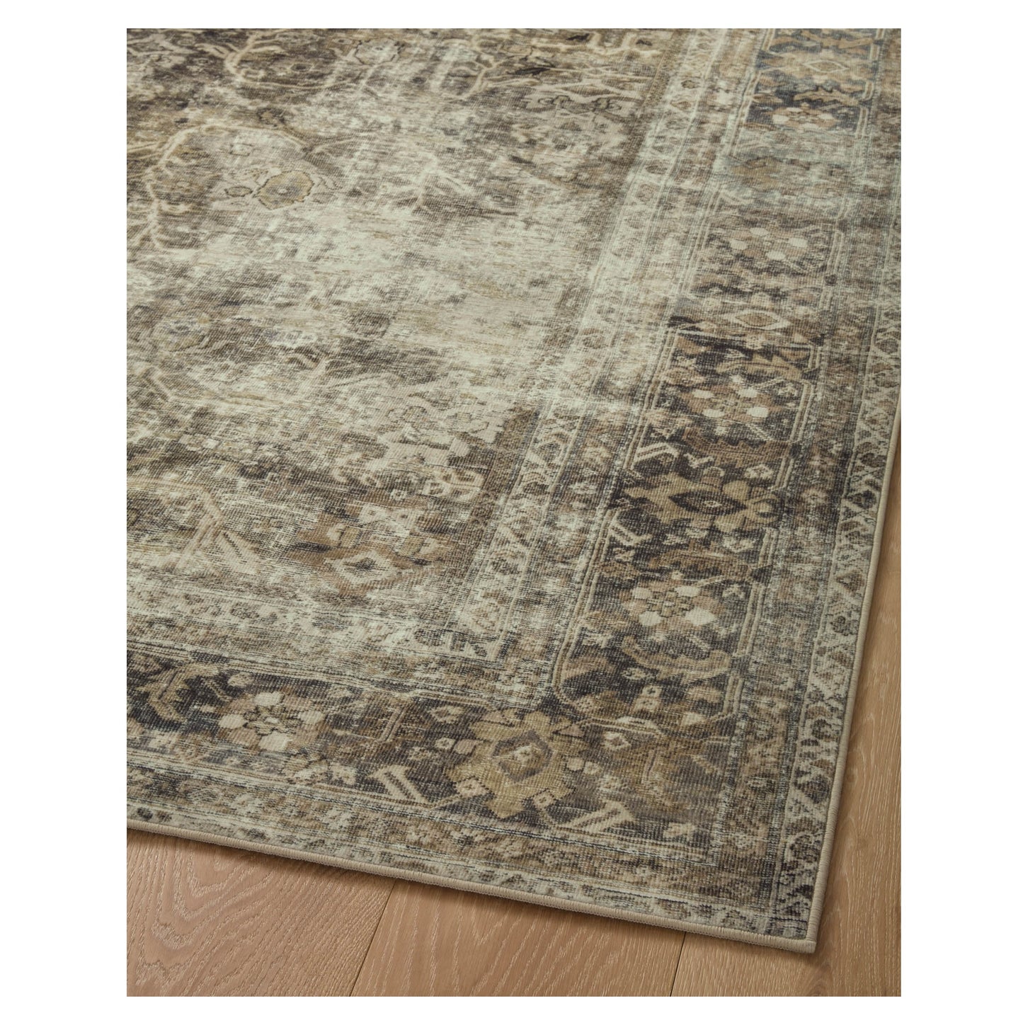 Sinclair Pebble Taupe Rug corner on wood floor