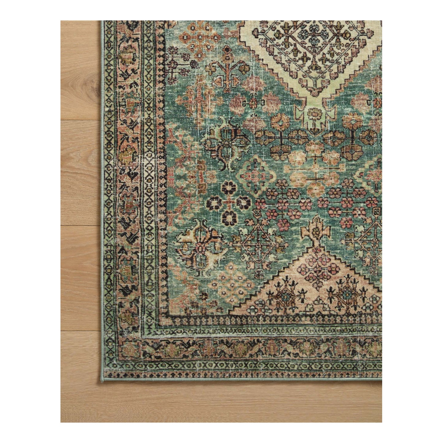 Sinclair Turquoise Multi Rug corner on wood floor
