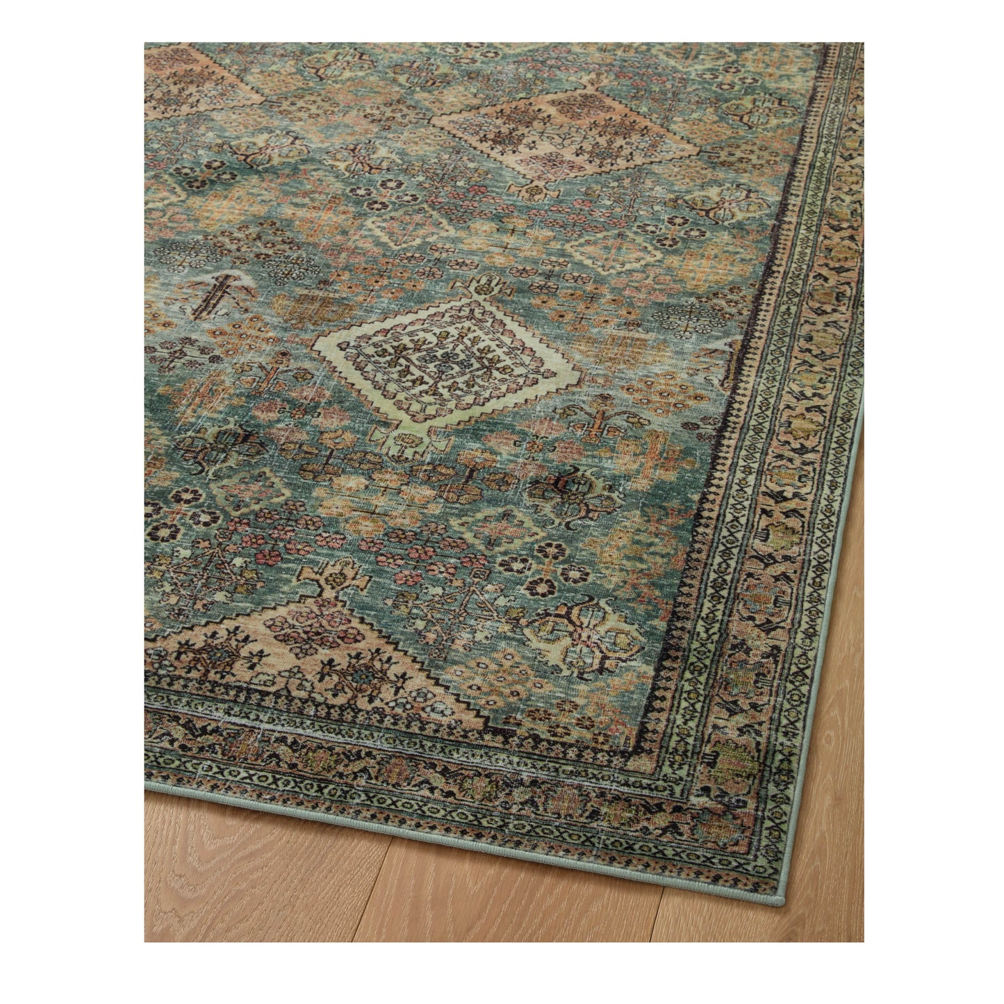Sinclair Turquoise Multi Rug corner on wood floor