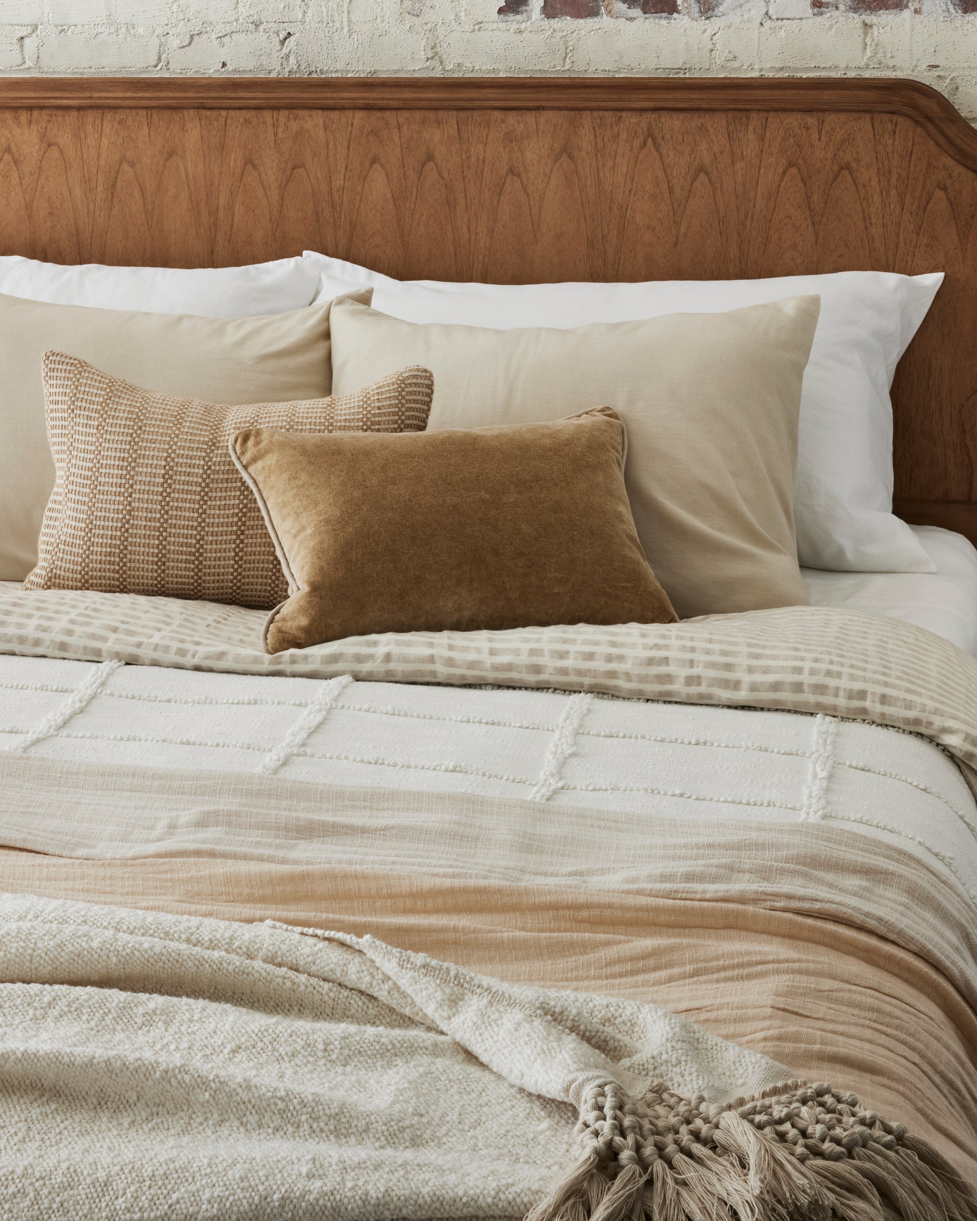 Angora Tassel Throw at the foot of bed layered with another throw blanket