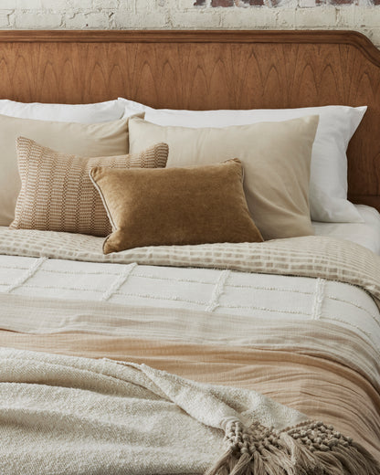 Angora Tassel Throw at the foot of bed layered with another throw blanket