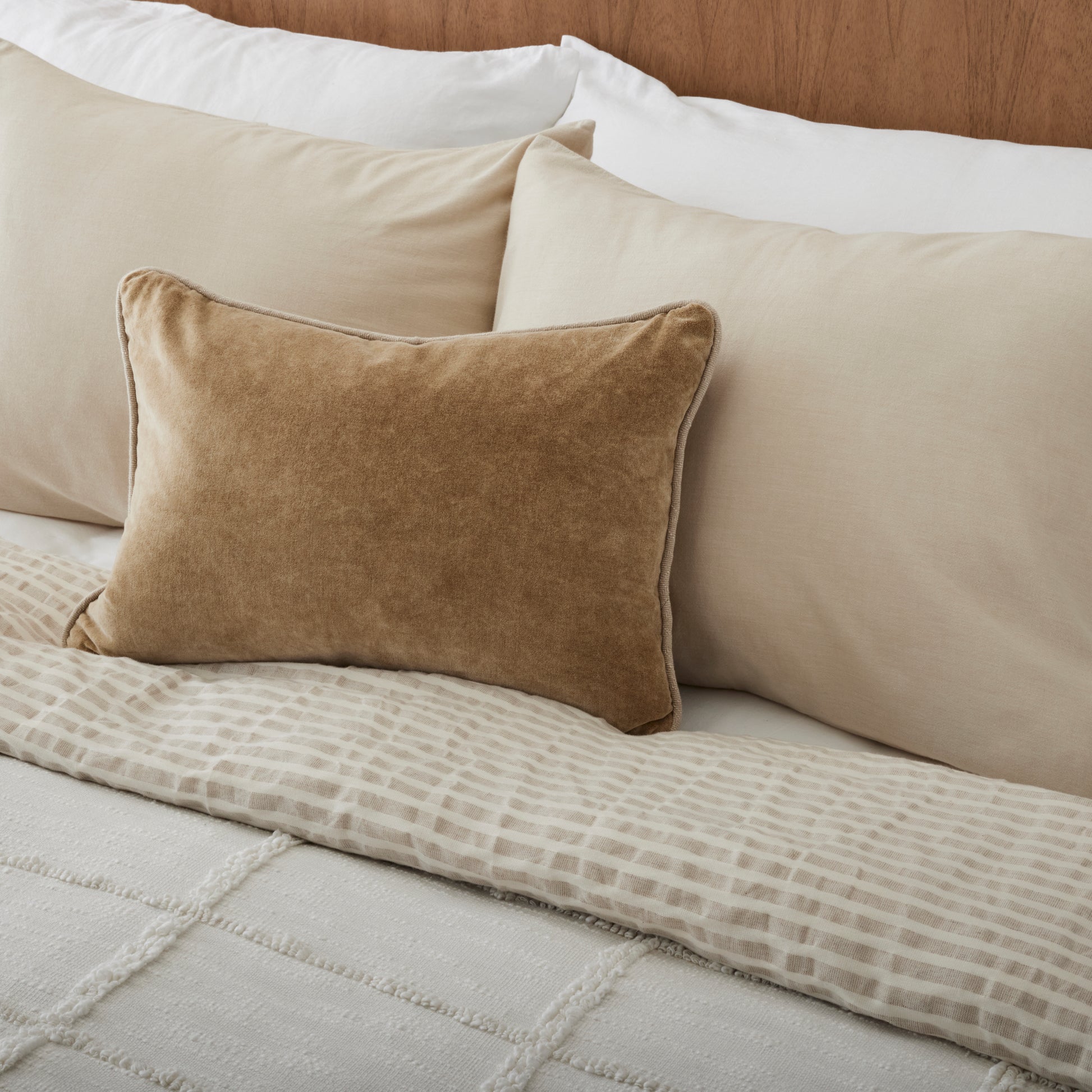 Optic White Textured Cotton Coverlet on a made bed with throw pillow