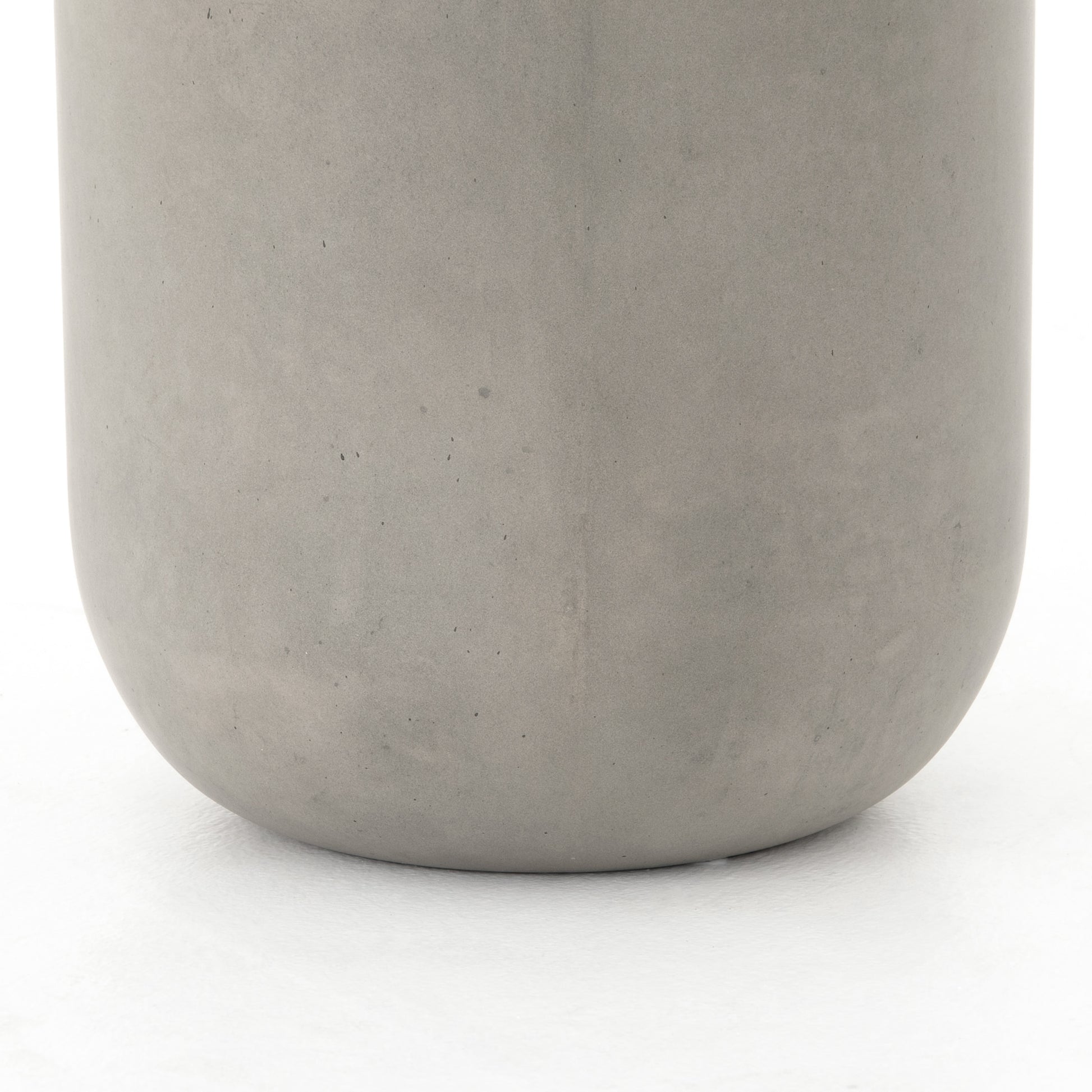 modern grey cylindrical end table with plaster finish