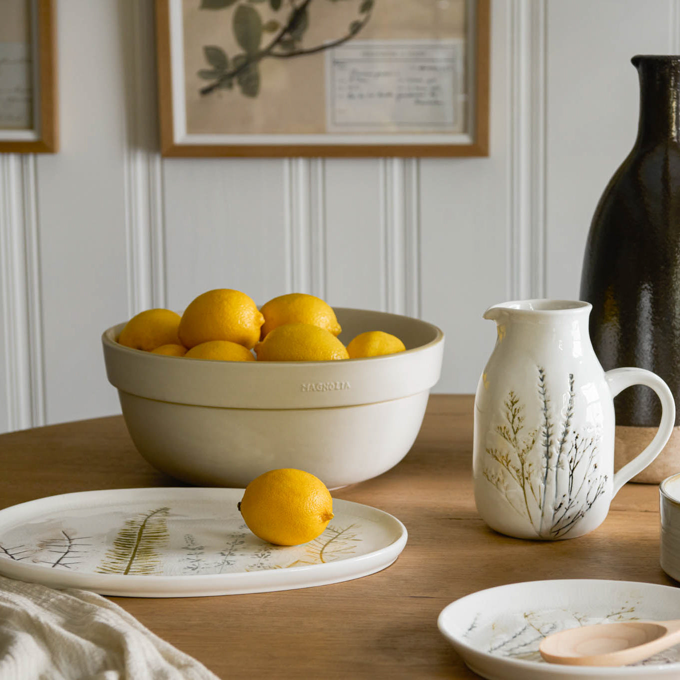 Pressed Floral Ceramic Pitcher on table next to bowl of oranges