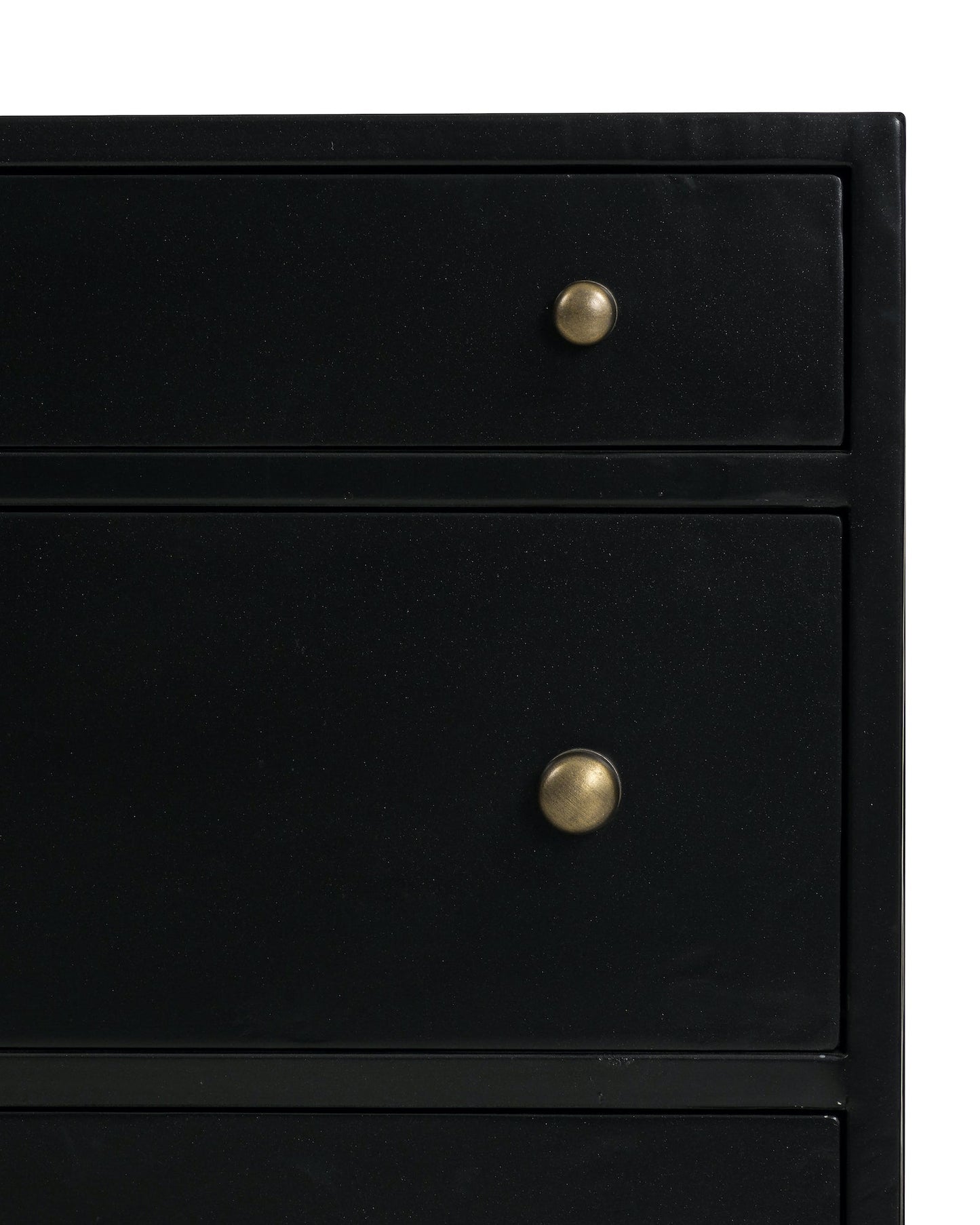 black metal nightstand with three drawers and brass knobs