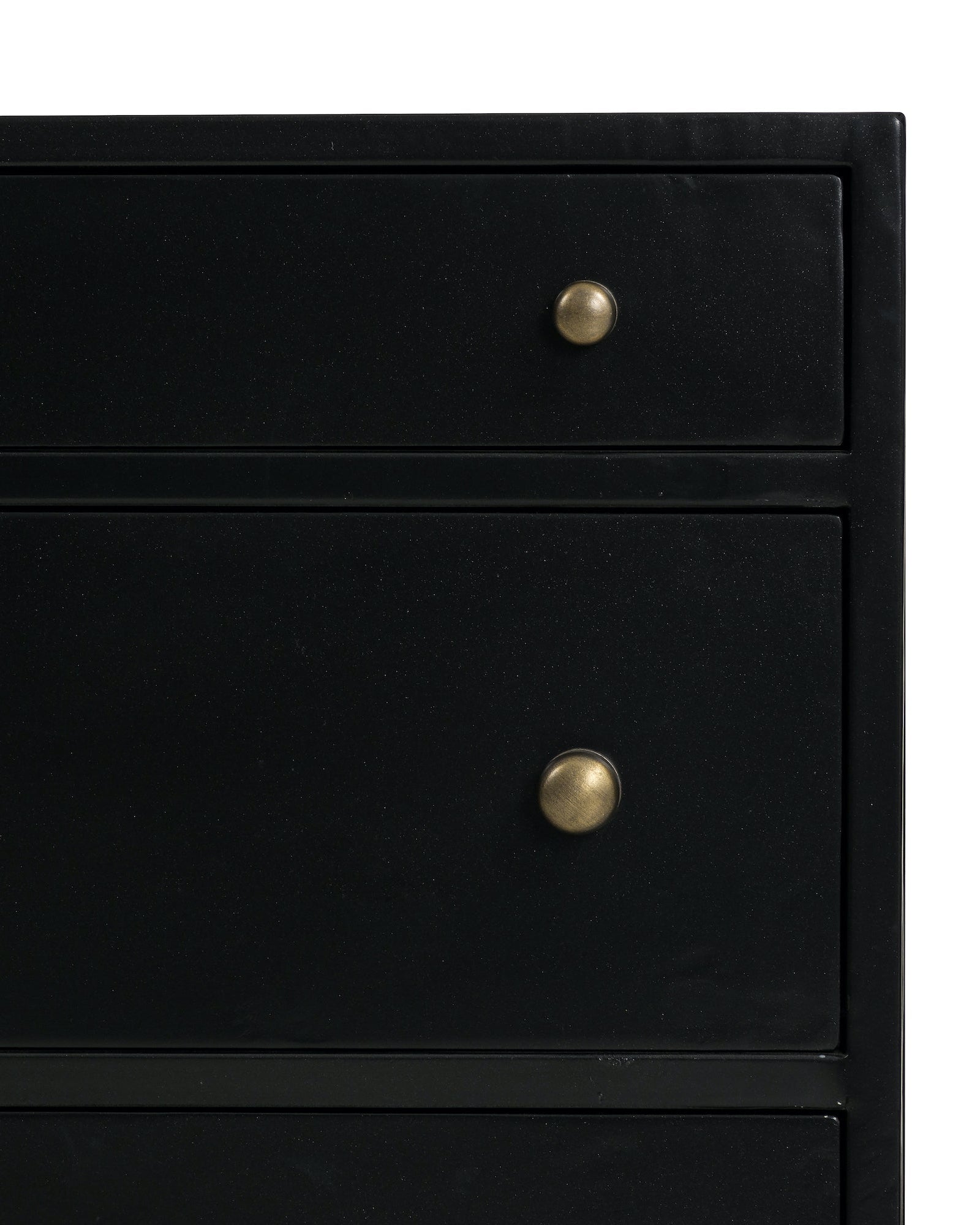 black metal nightstand with three drawers and brass knobs