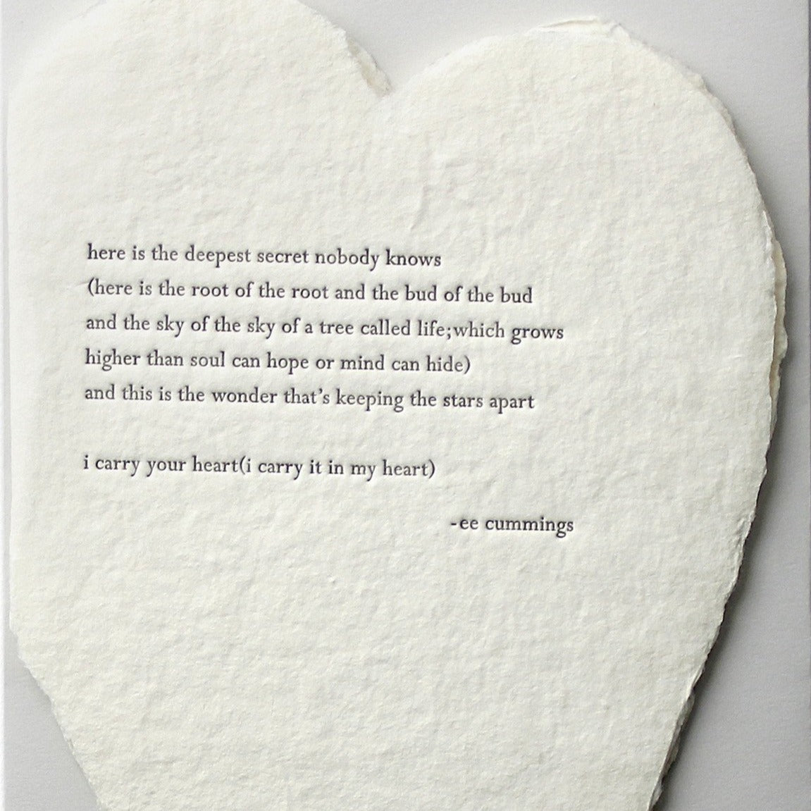 deckled paper heart with quote from ee cummings embossed
