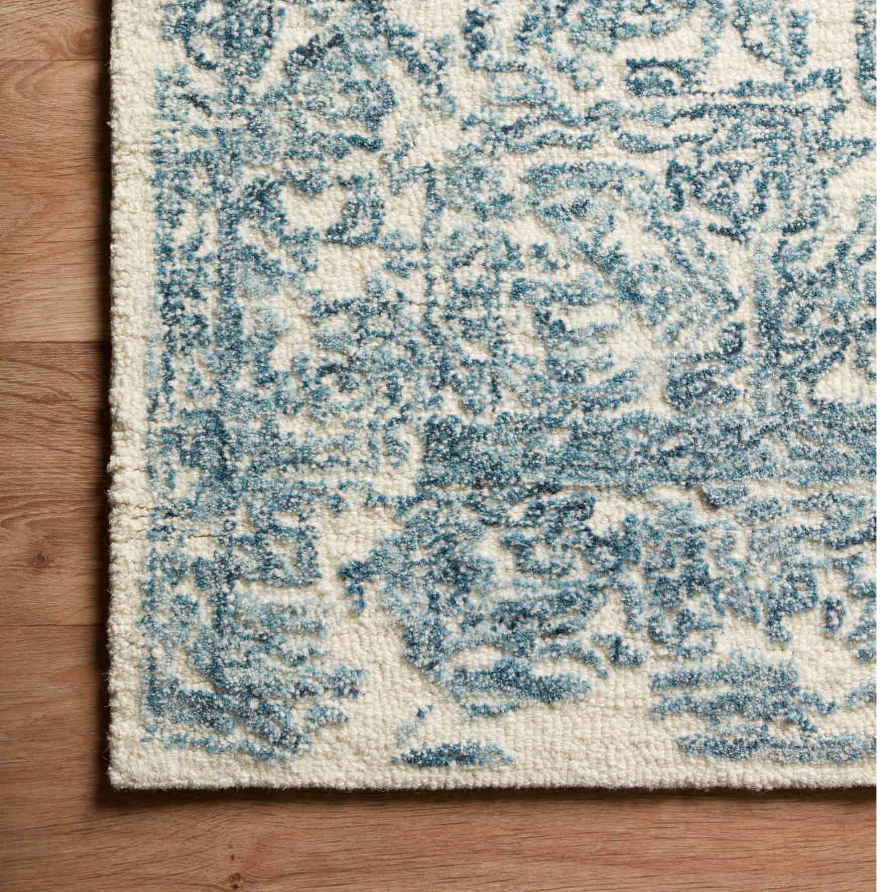 cream rug with blue traditional detail